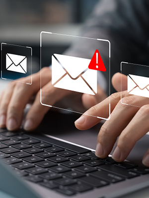 Hands typing on a keyboard with a message alert icon