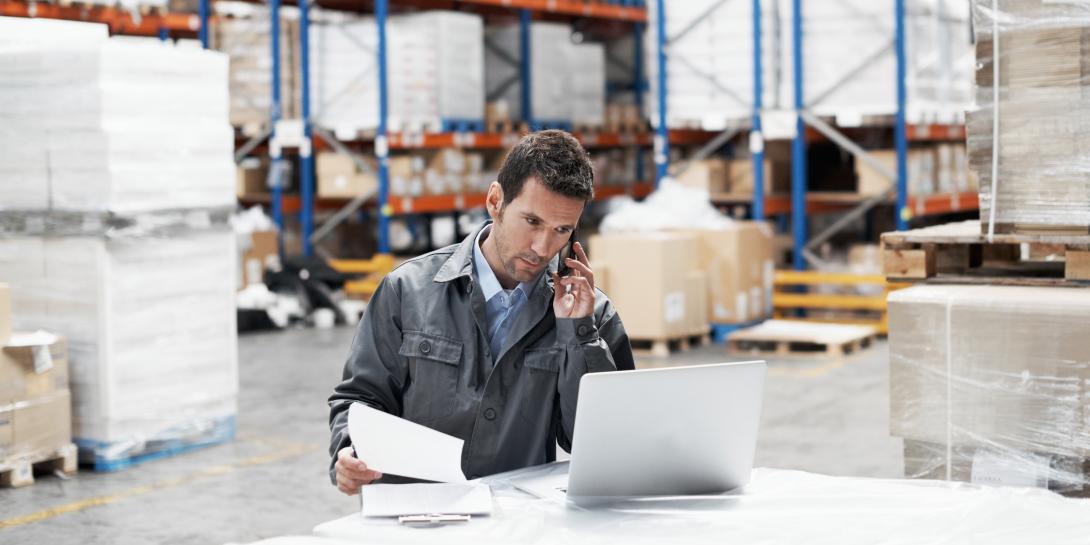 Man looking at a statement while working